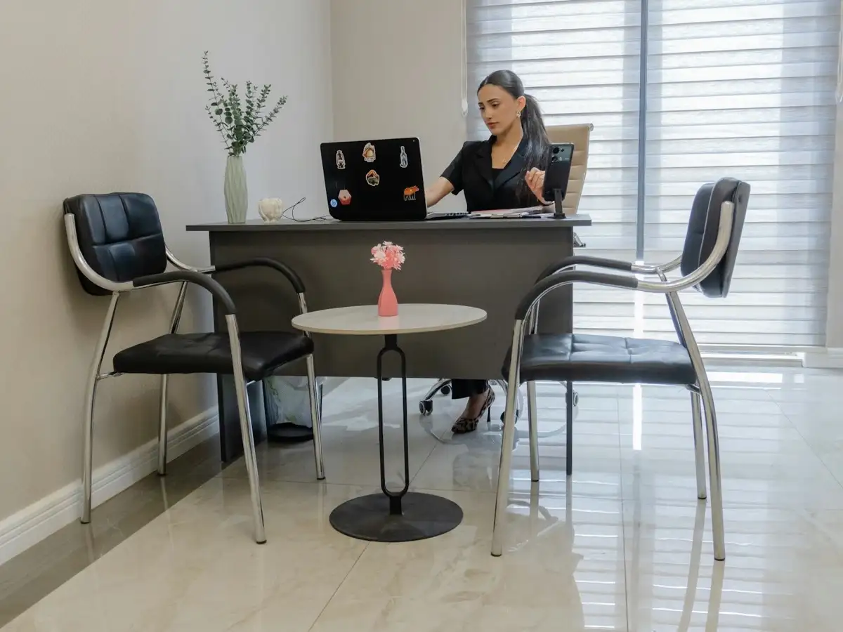 Desk with a laptop and phone, workspace setting