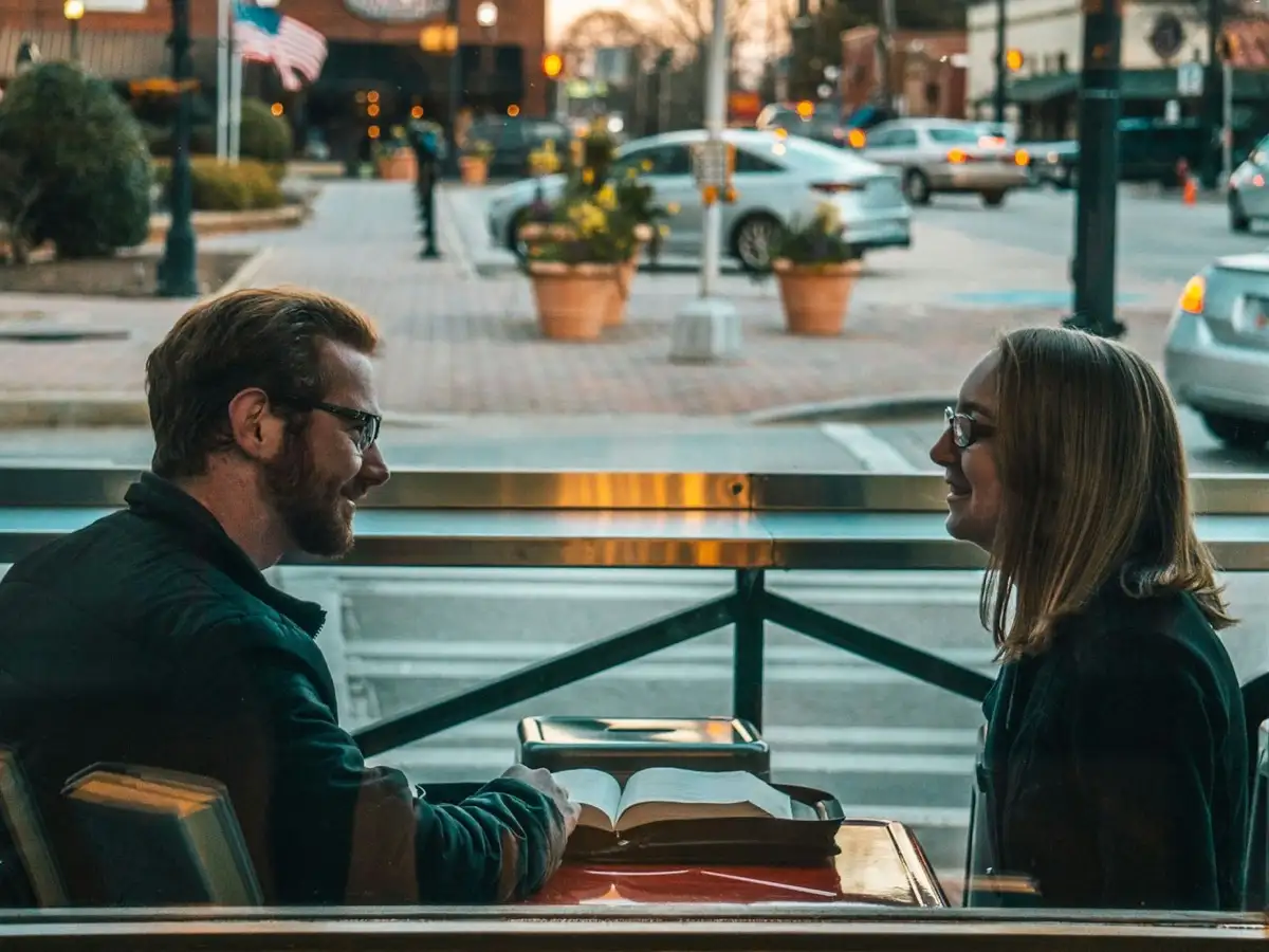 Two people sitting and talking during the day