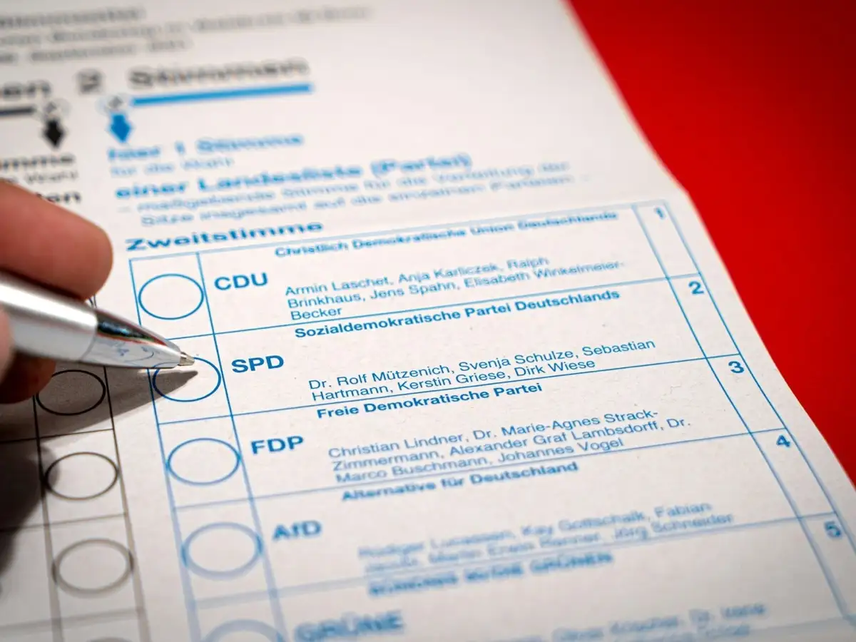 Person filling out a form, reviewing details carefully