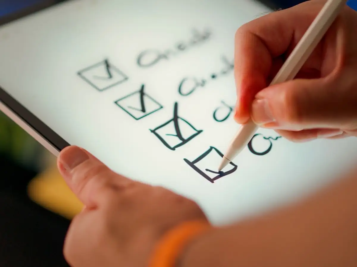 Hand marking items on a printed checklist