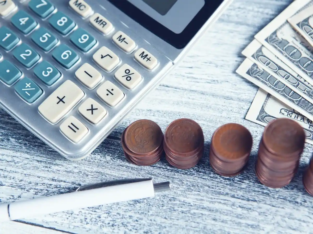 Coins and calculator on a table for cost planning