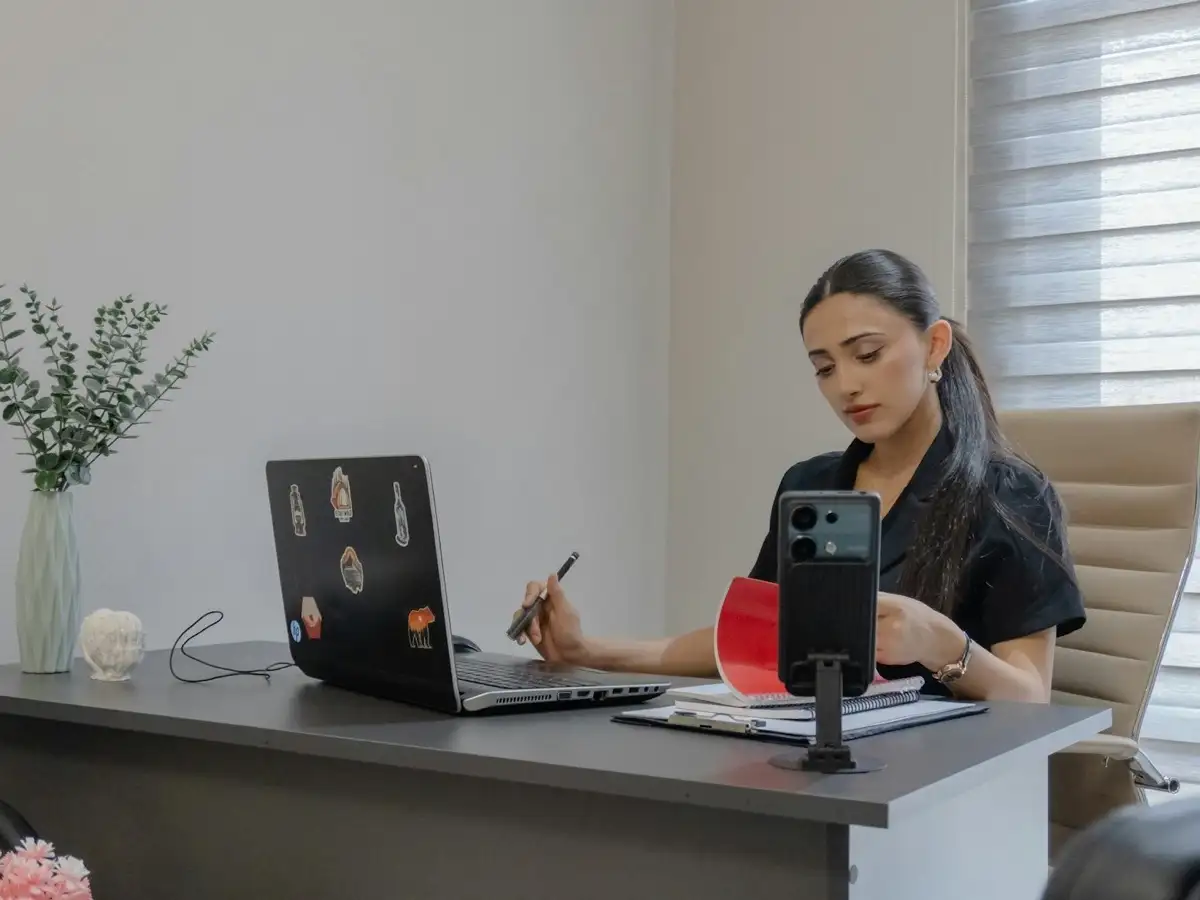 Desk workspace with a laptop and phone