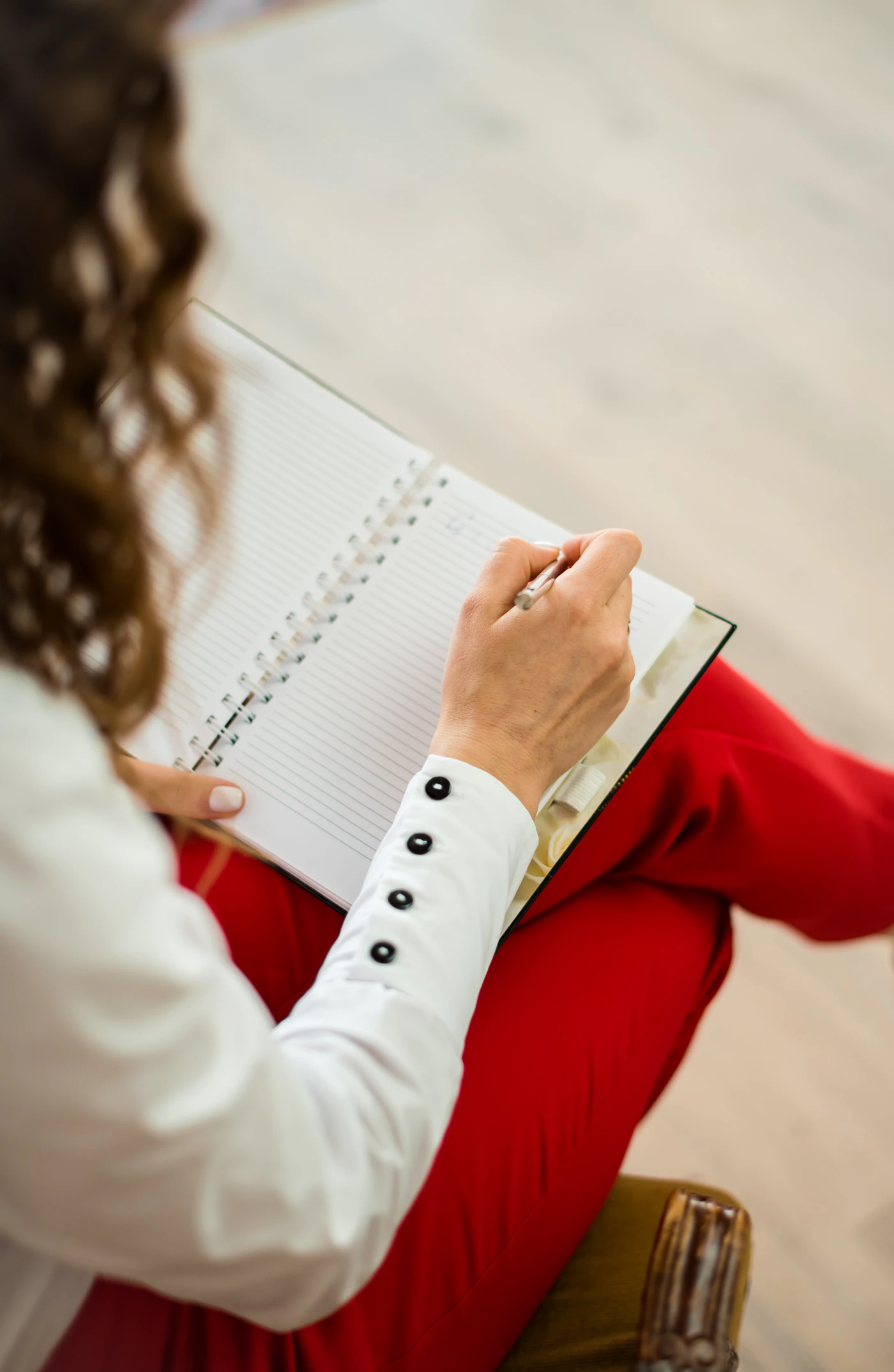 Coach taking notes in a notebook during a session