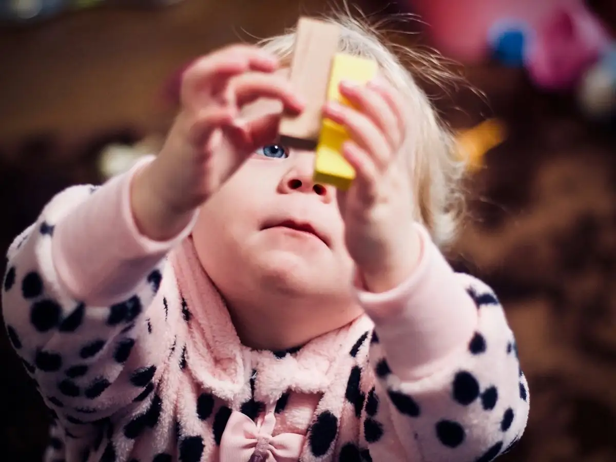 Child concentrating while playing with building blocks