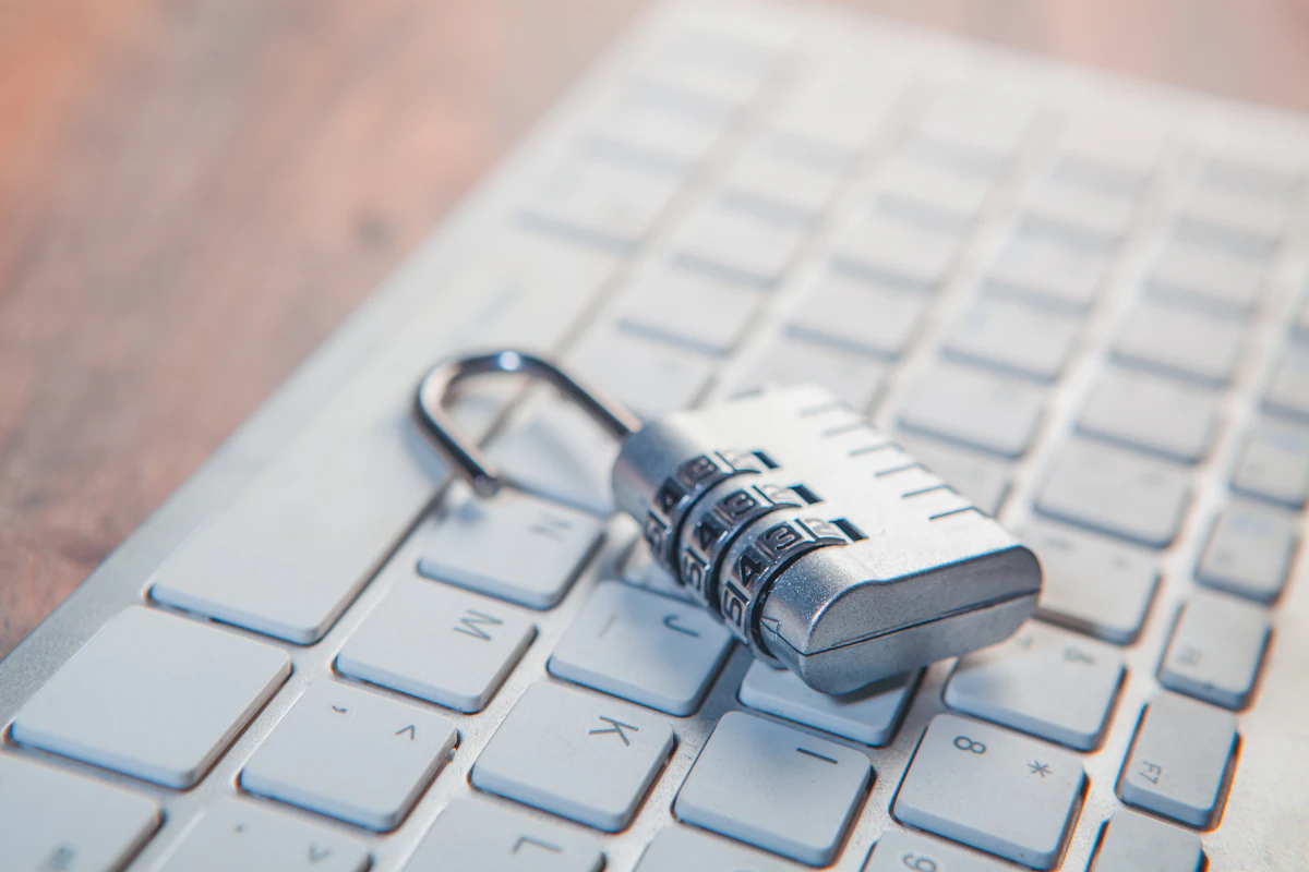 An open padlock resting on a keyboard, representing privacy and digital boundaries